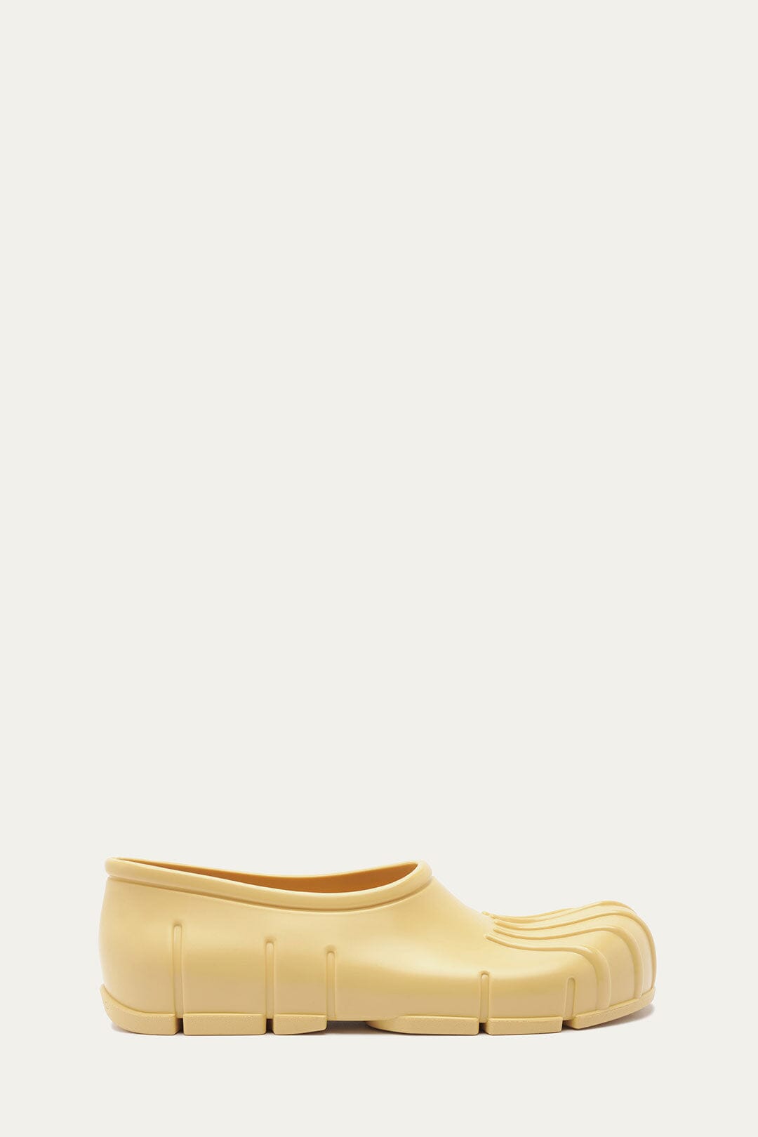 FARM Rio model wearing the Butter Yellow Monstera Rain Shoe