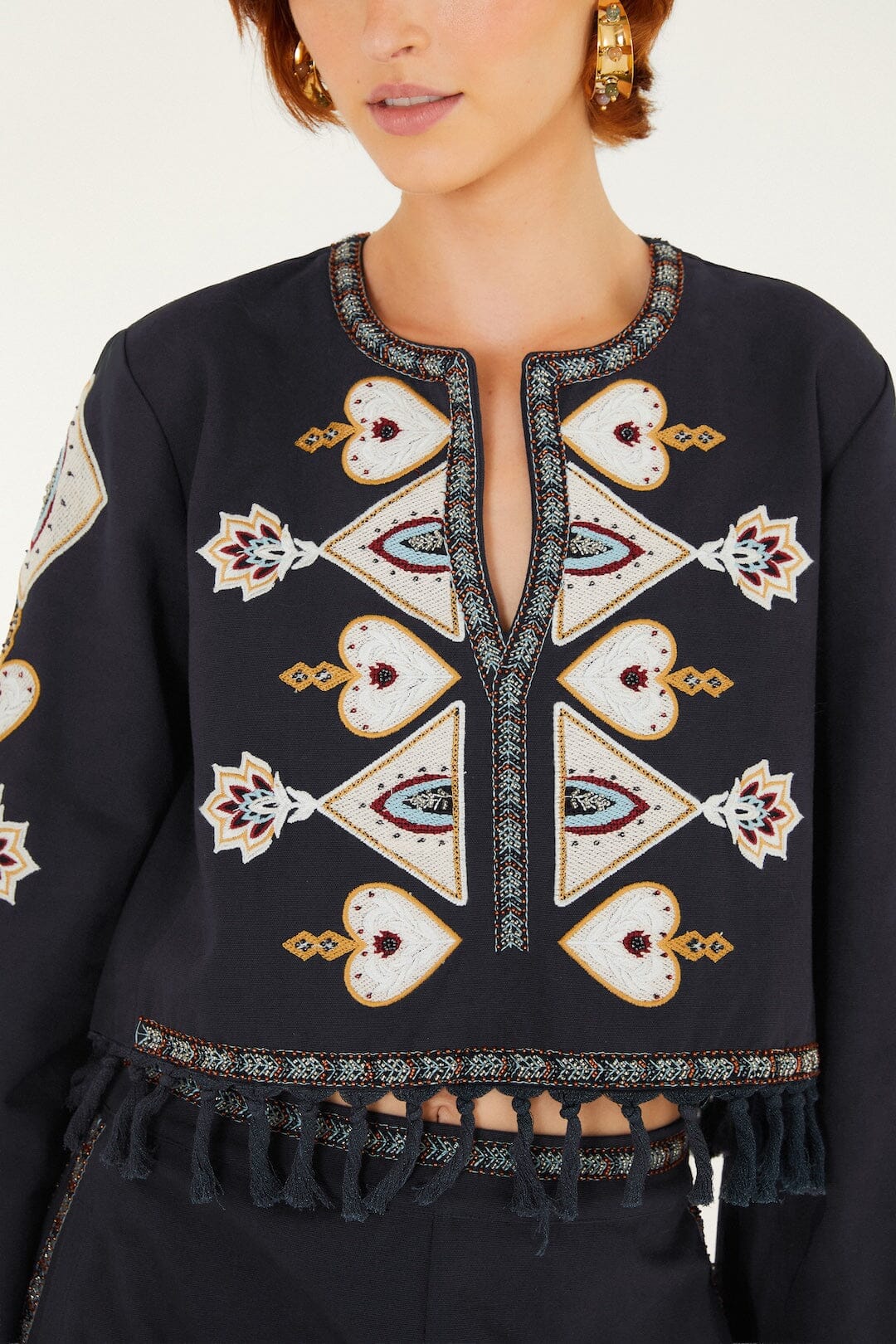 FARM Rio model wearing the Embroidered Long Sleeve Fringe Crop Top