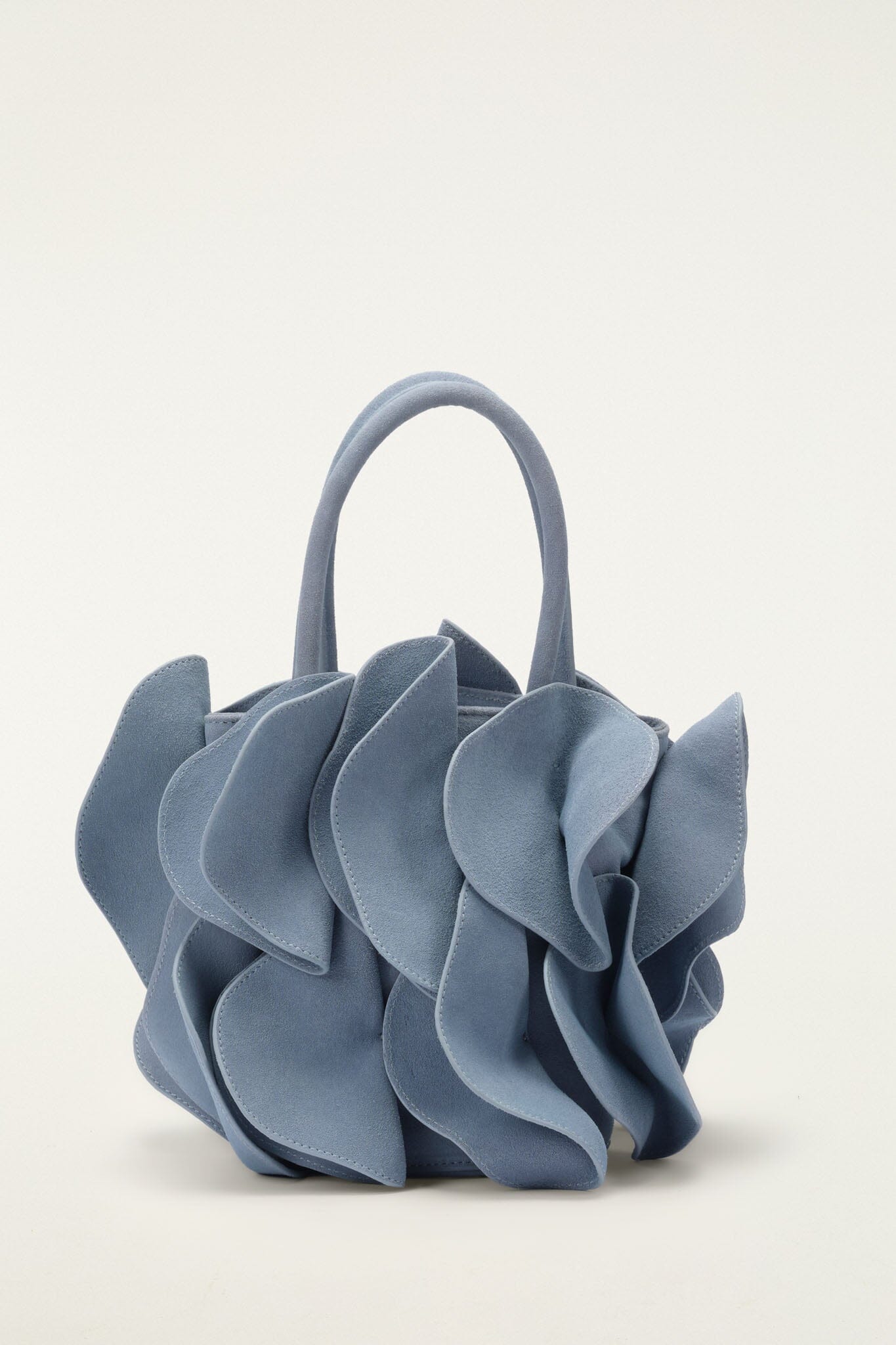 FARM Rio model wearing the Light Blue Suede Flower Handbag