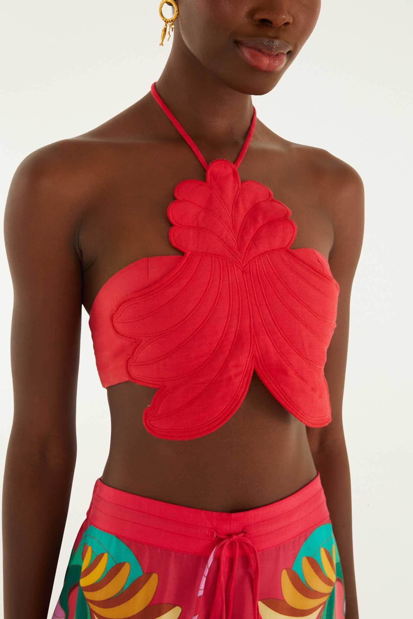 FARM Rio model wearing the Red 3d Shell Halter Neck Crop Top