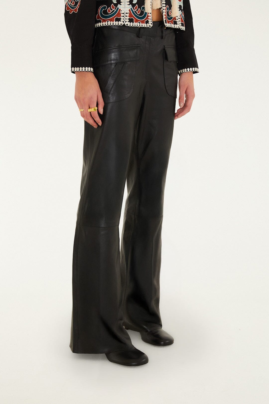 FARM Rio model wearing the Riveted Wide-Leg Leather Trousers