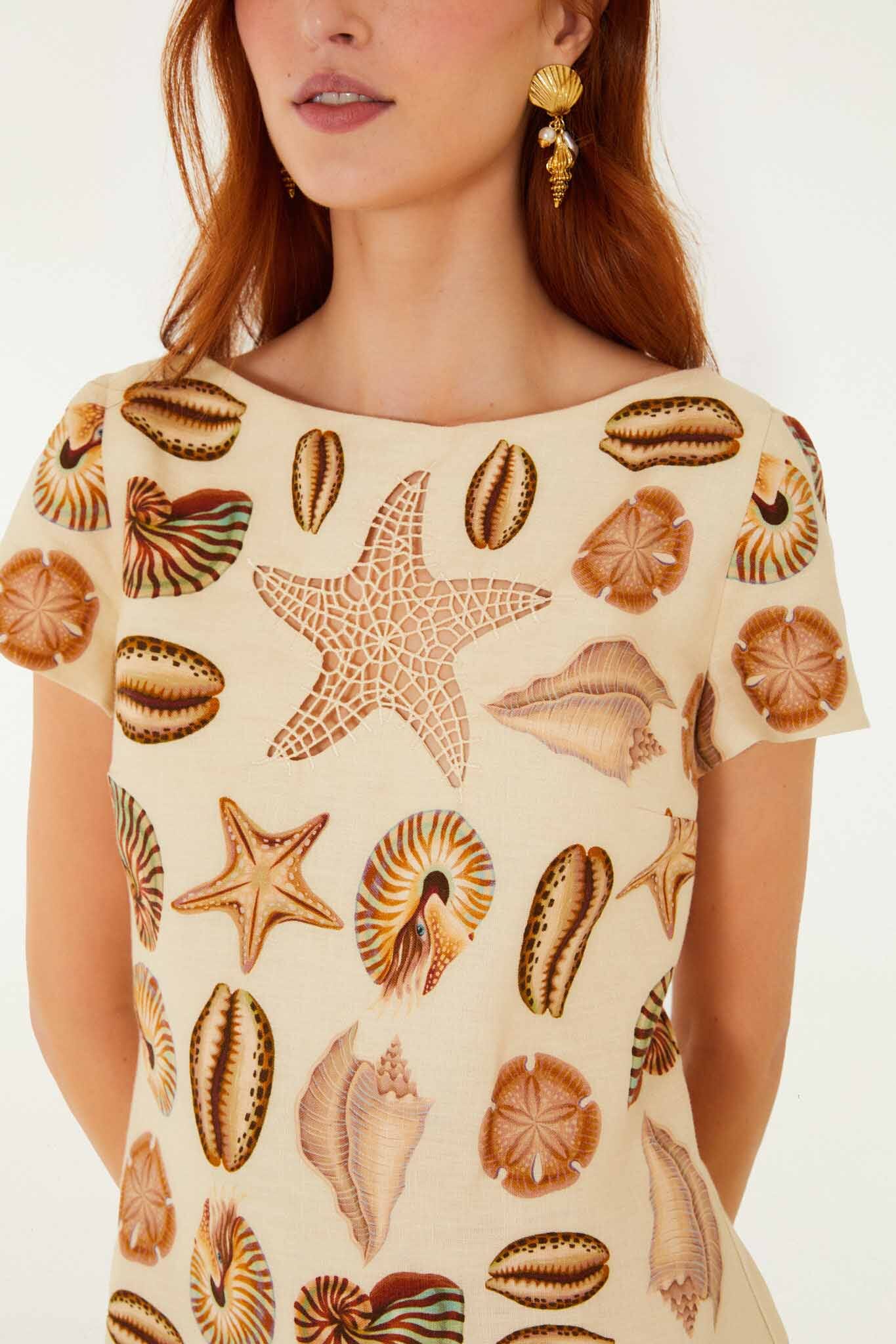 FARM Rio model wearing the Sand Marine Shells Short Sleeve Mini Dress